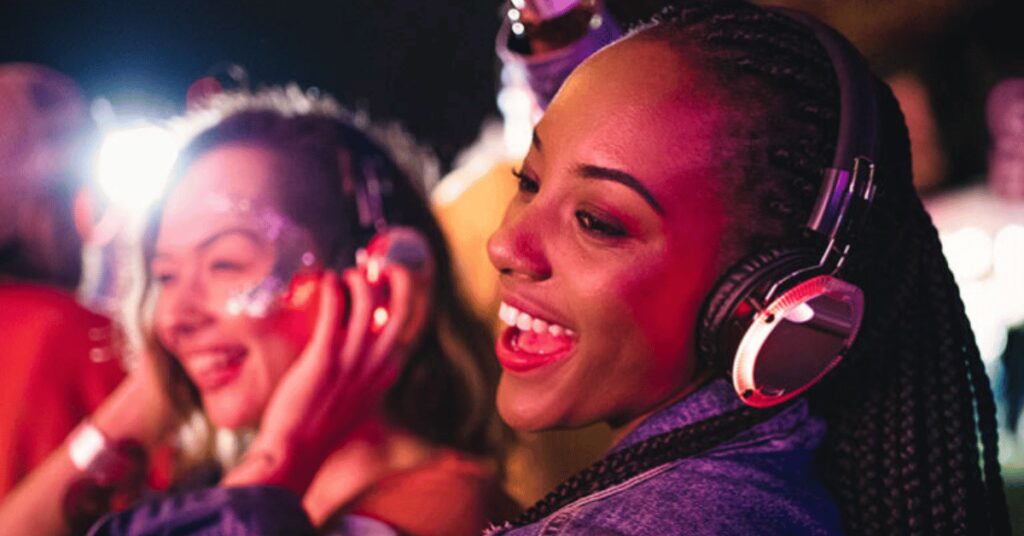 woman using headphones to protect ears at loud show