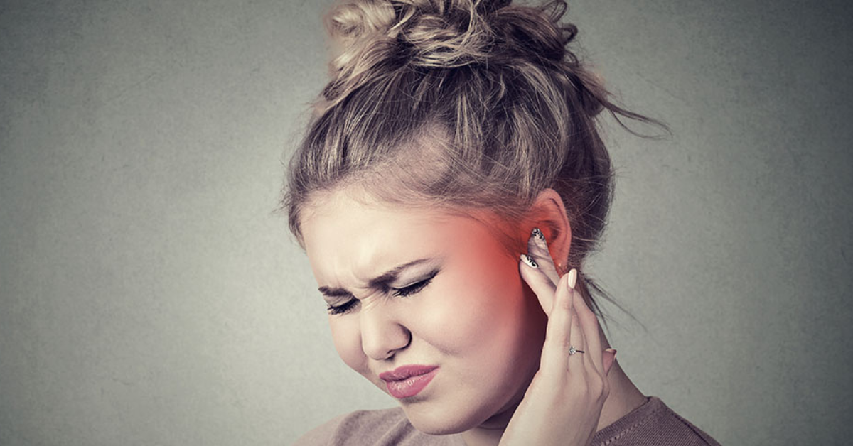 woman suffering from tinnitus pain