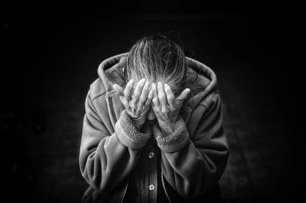 woman holding her head in her hands