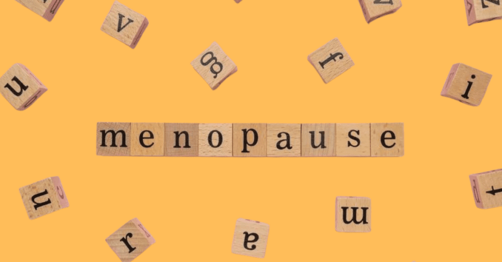 Blocks that spell menopause on a yellow background