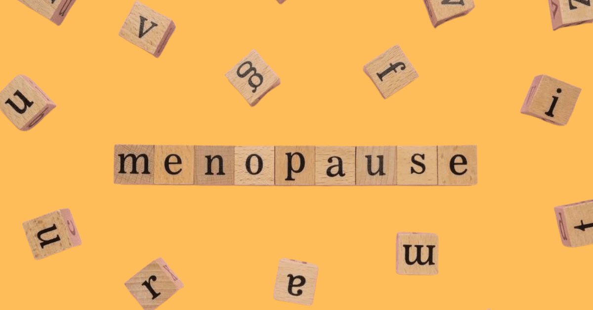 Blocks that spell menopause on a yellow background