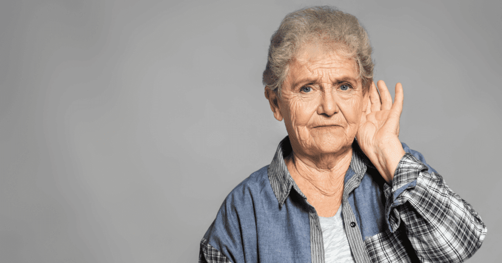 Older woman holding her ear