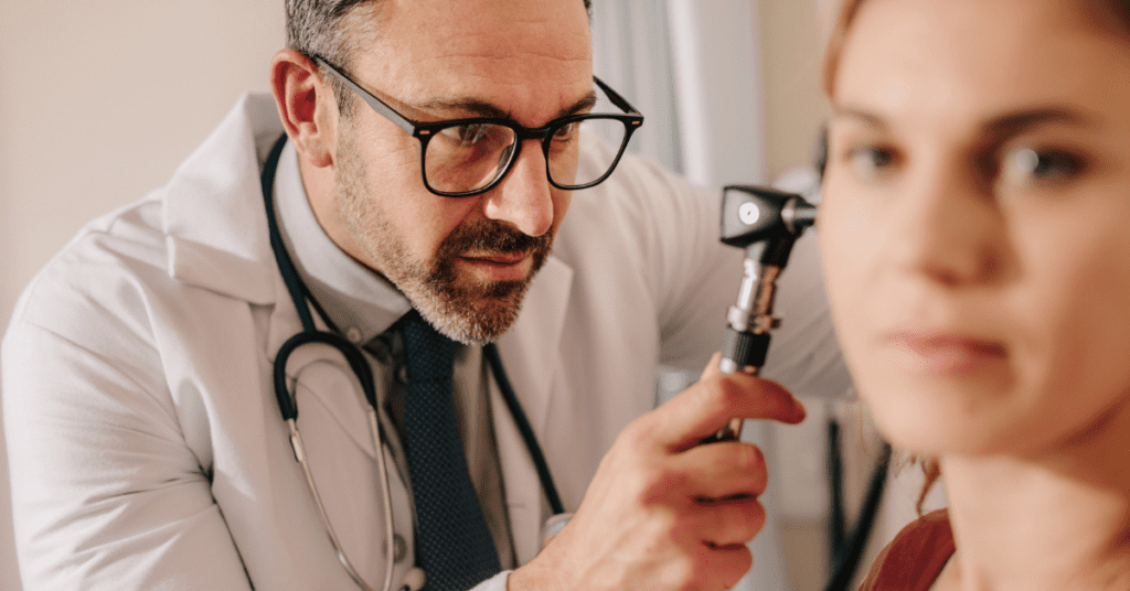 Doctor looking at a woman's ear