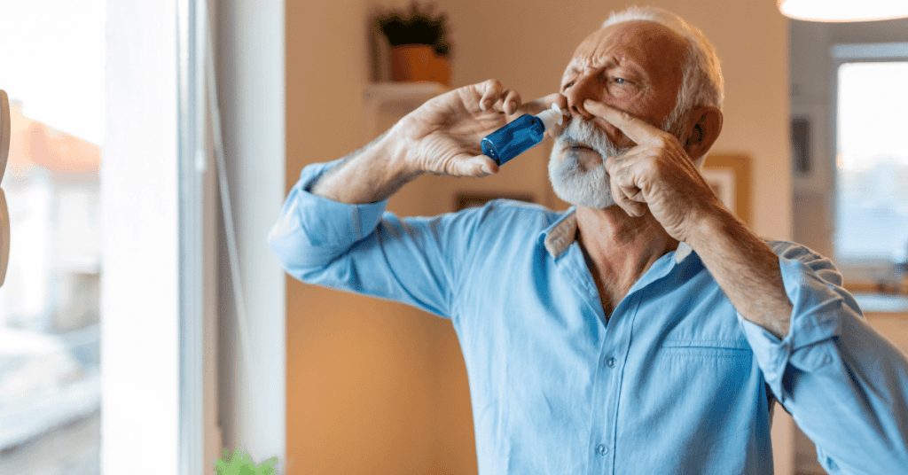 Man using nasal spray