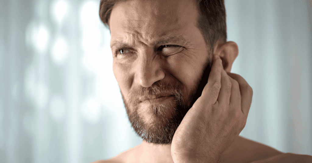 Man holding his outer ear
