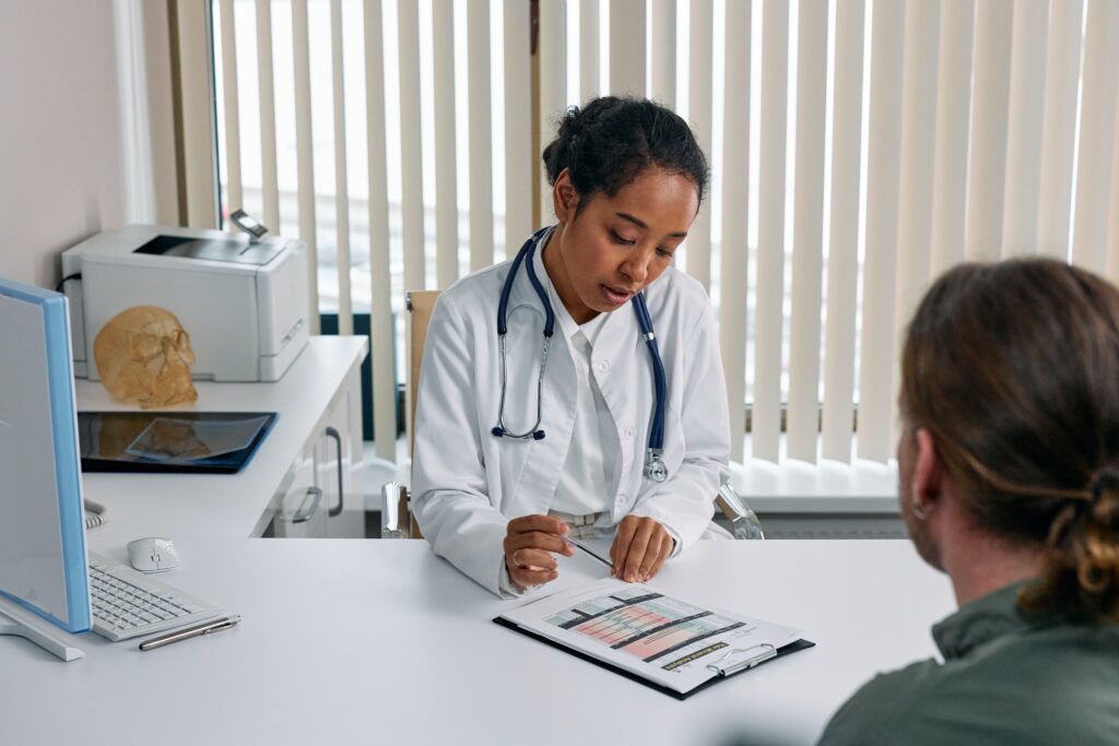 A patient speaking with a doctor at a desk