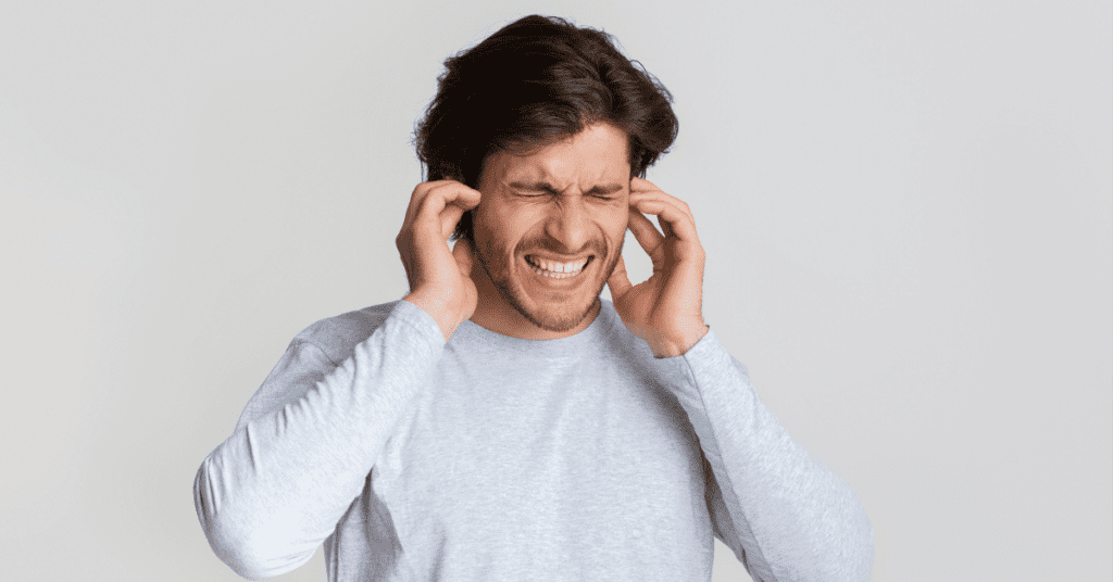 Man holding his ears in pain