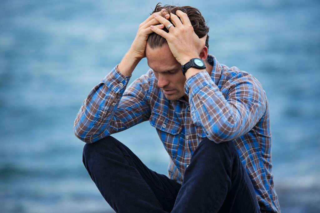 Man holding his head in his hands