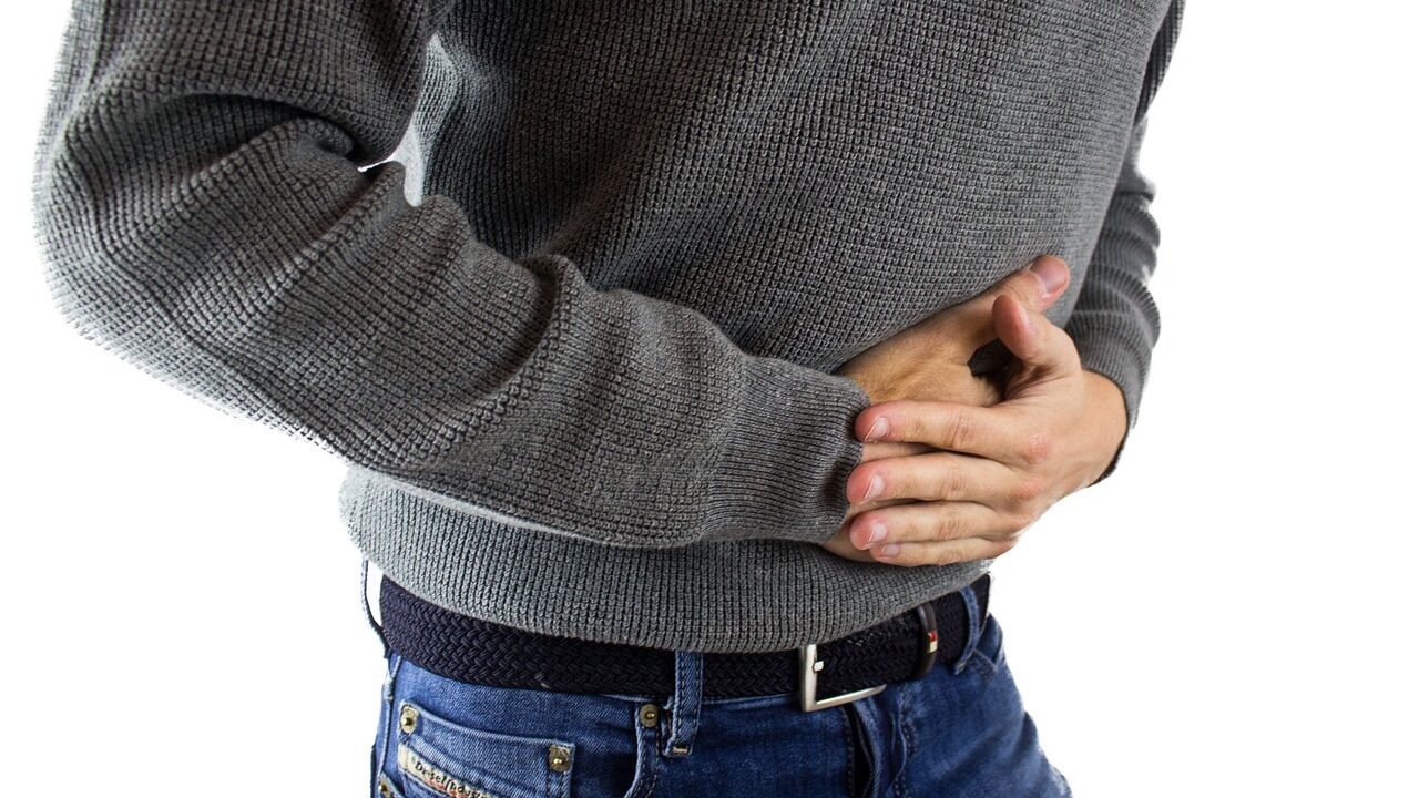 Person holding their stomach in pain