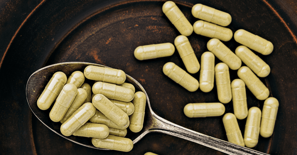 Quercetin capsules on a spoon