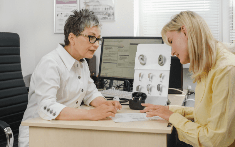 Woman talking to her doctor about getting hearing aids