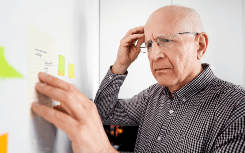 Confused man reading notes that he left for himself