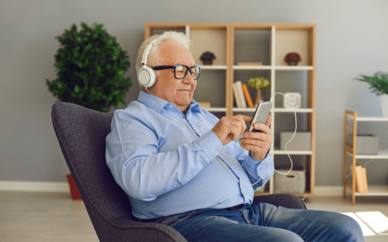 Man using over the ear headphones to listen to his phone
