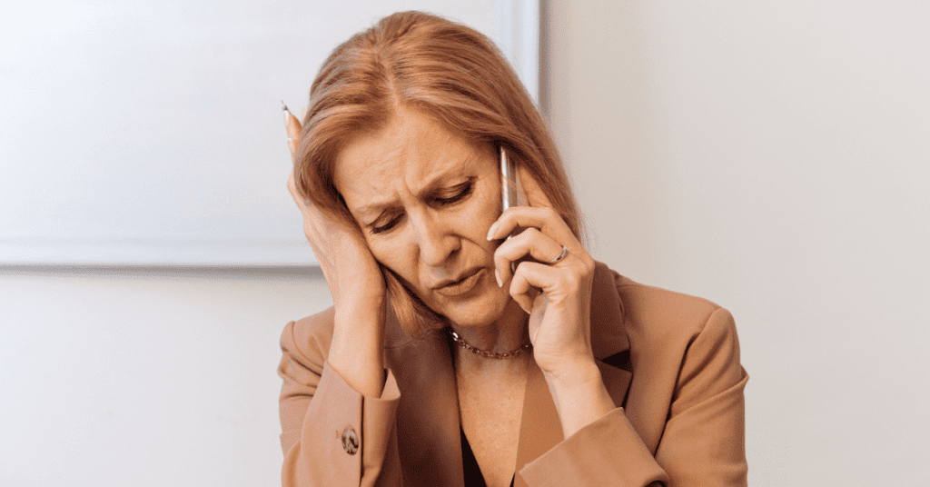 Woman talking on the phone and having a hard time hearing