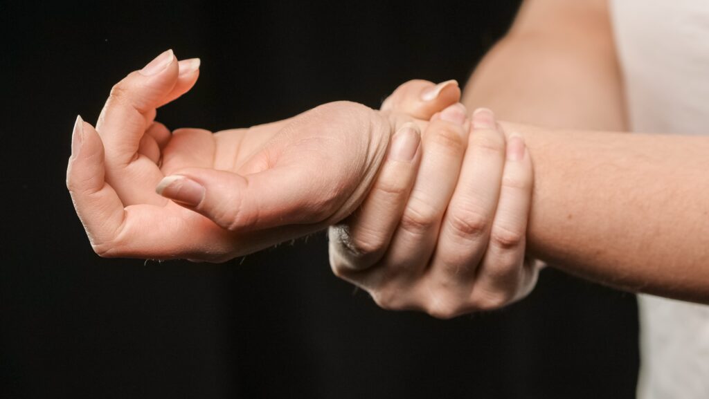 Person with arthritis holding their wrist