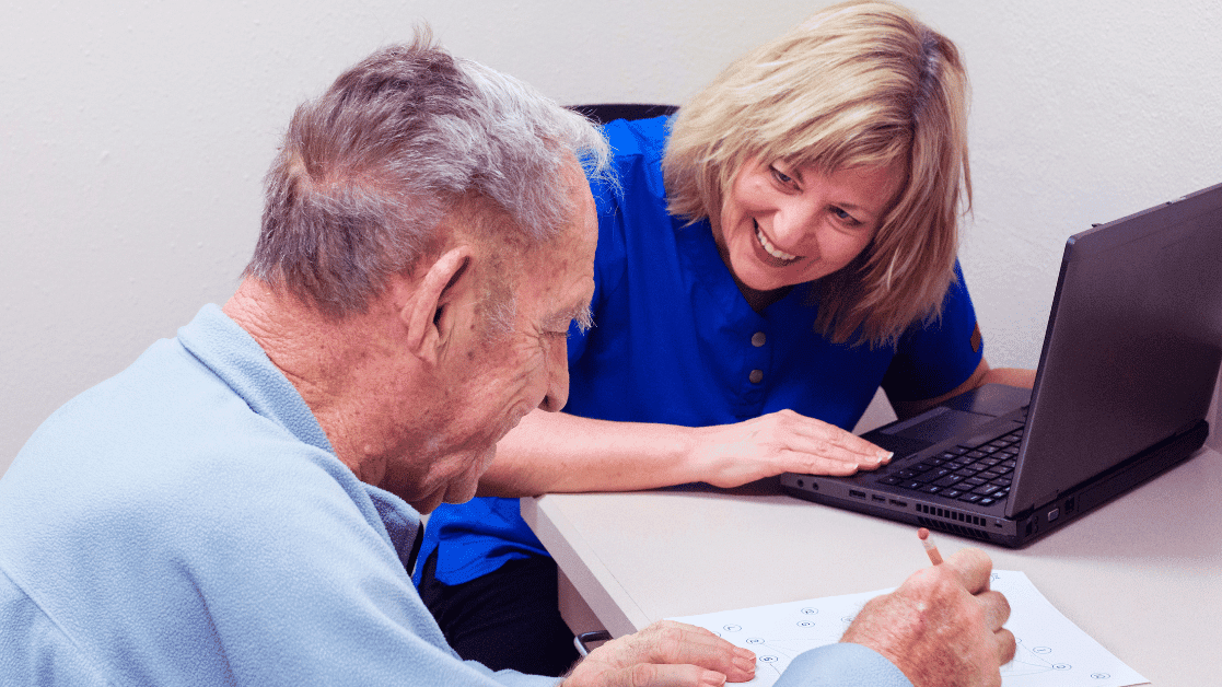 Two older people working with each other