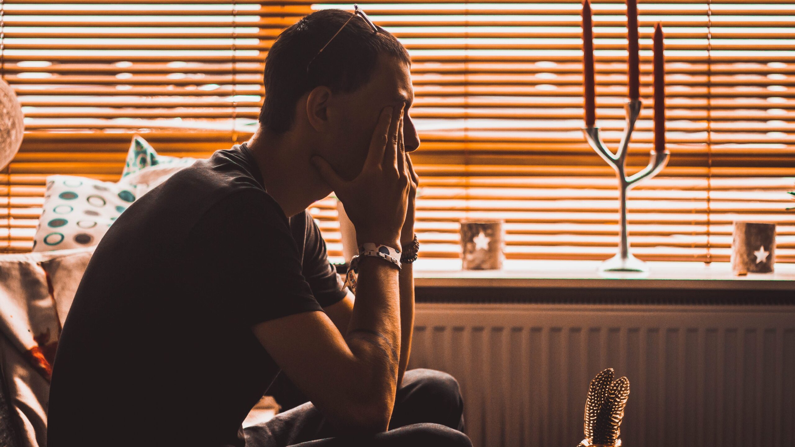 Stressed man holding his head in his hands