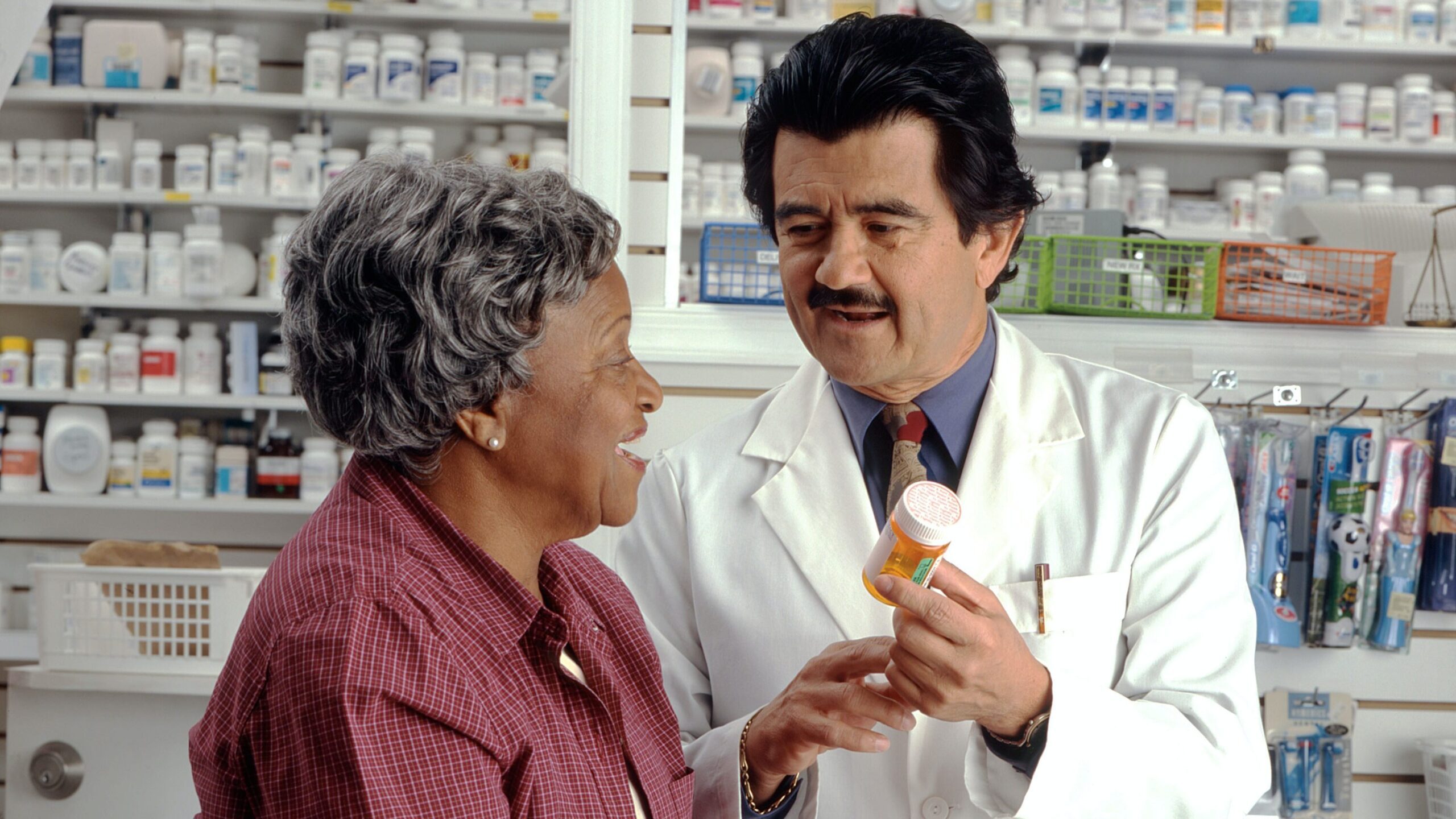 Woman picking up a prescription at a pharmacy