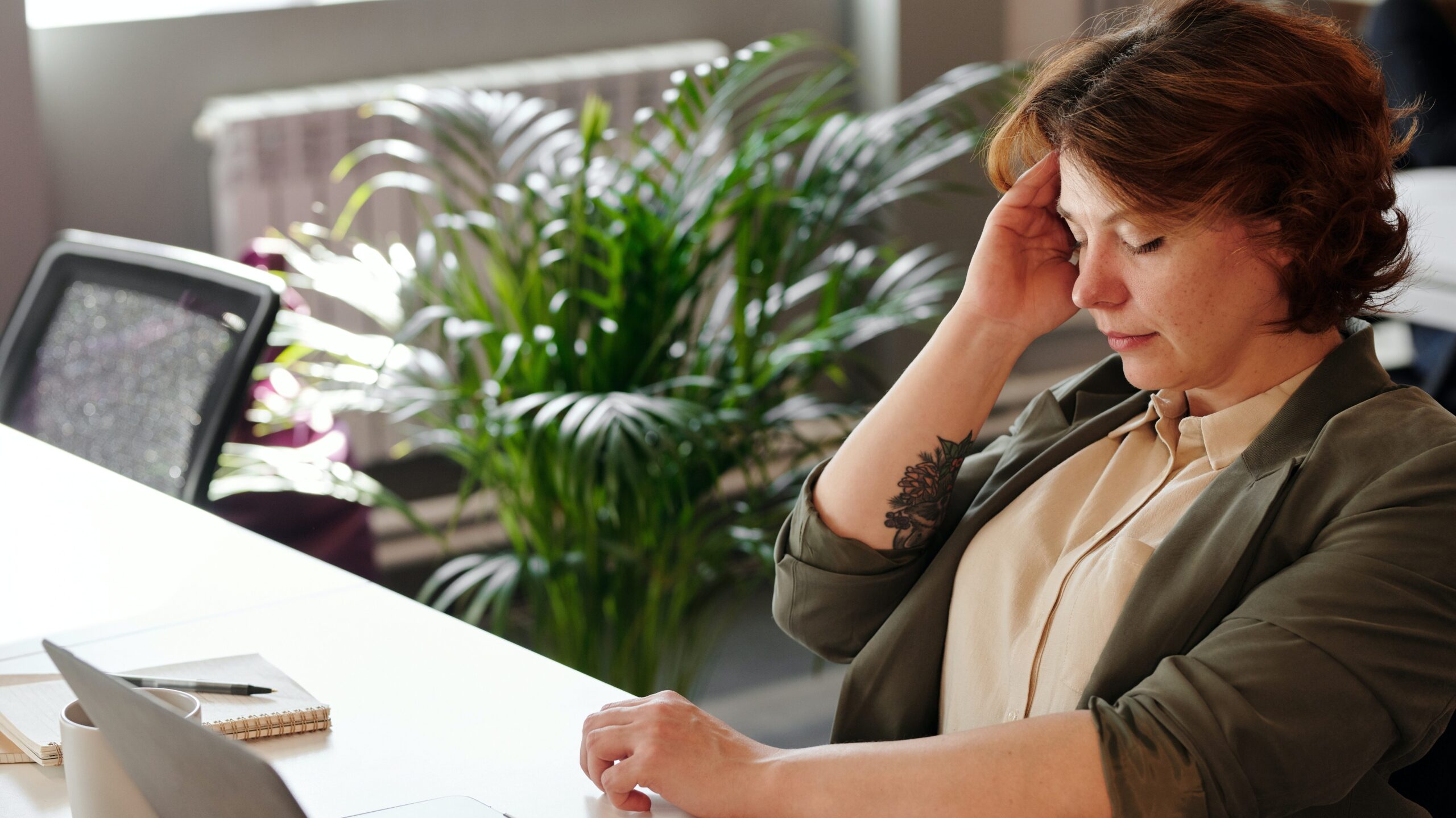 Tired woman sitting at a desk