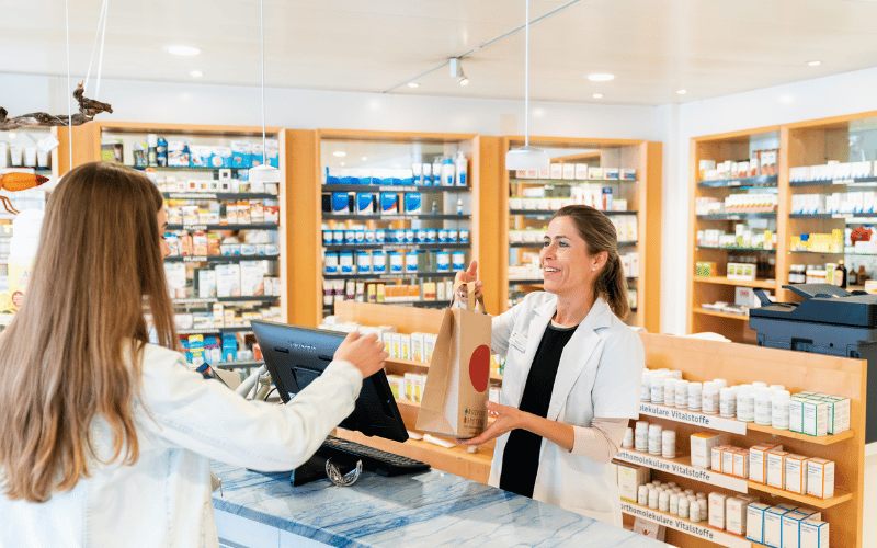Woman picking up prescriptions from a pharmacy