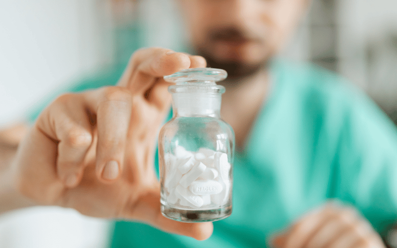 Man holding a jar of magnesium supplements