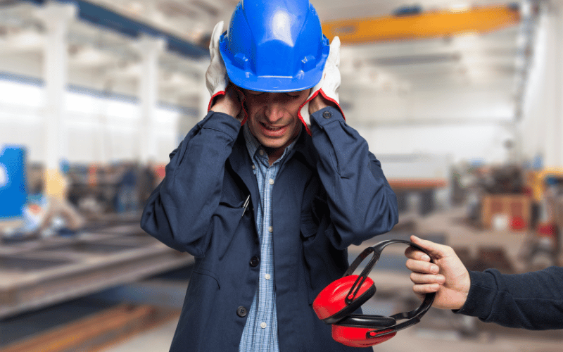 Man covering his ears at a construction job site