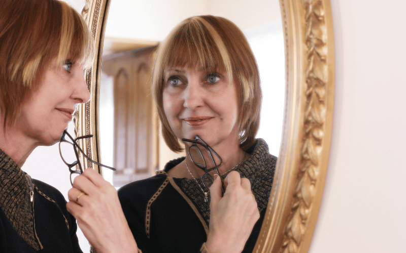 Woman looking at herself in the mirror